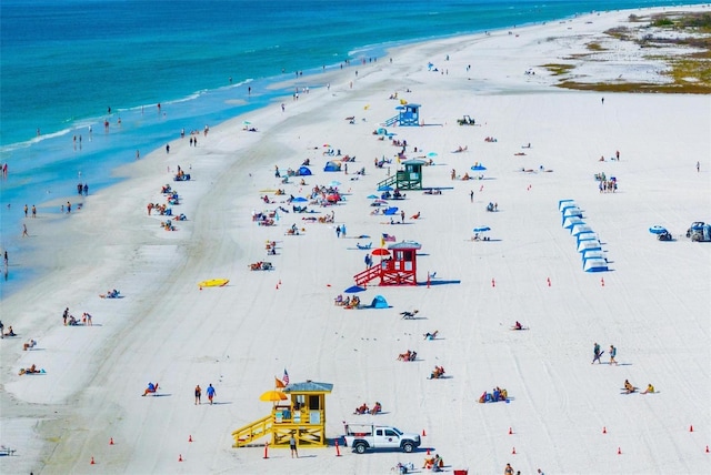 aerial view with a water view and a beach view