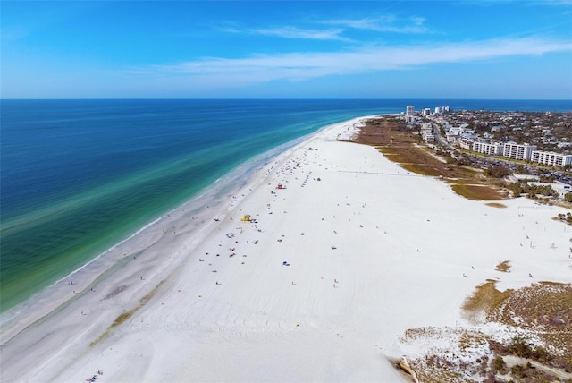 birds eye view of property with a water view and a beach view