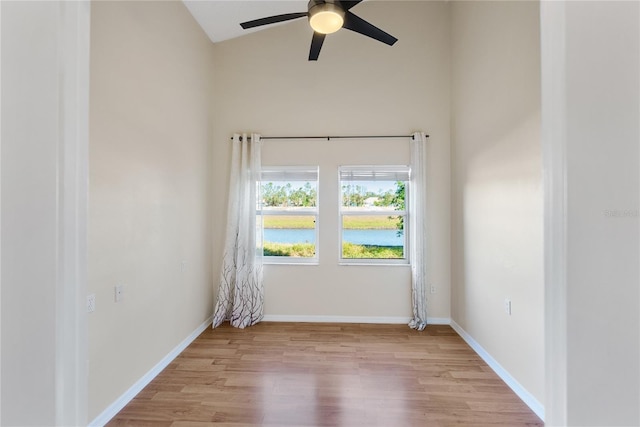 unfurnished room featuring ceiling fan, lofted ceiling, and light wood-type flooring