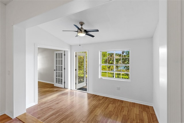 spare room with light hardwood / wood-style floors, ceiling fan, and lofted ceiling