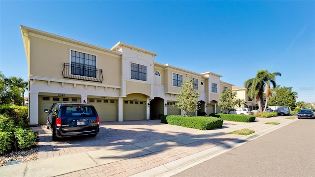 4046 Overture Cir Unit 4046, Bradenton, FL 34209 - view of front of house with a garage, stucco siding, and decorative driveway