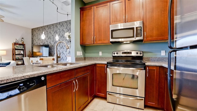 4046 Overture Cir Unit 4046, Bradenton, FL 34209 - kitchen with stainless steel appliances, light stone countertops, light tile patterned flooring, open floor plan, and a peninsula