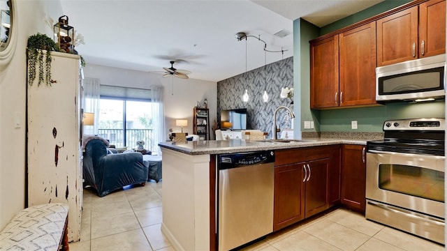 4046 Overture Cir Unit 4046, Bradenton, FL 34209 - kitchen featuring appliances with stainless steel finishes, open floor plan, light tile patterned floors, and a peninsula