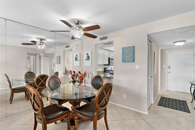 tiled dining area with ceiling fan