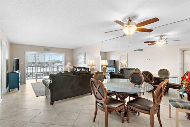 dining space featuring ceiling fan and light tile patterned flooring