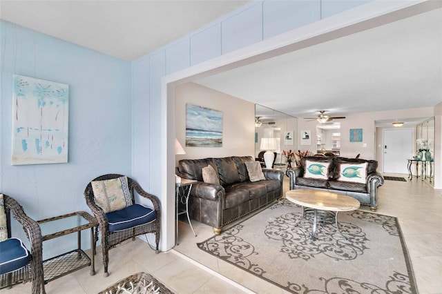 living room featuring ceiling fan and light tile patterned floors