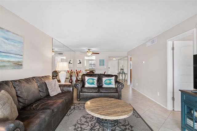 tiled living room with ceiling fan