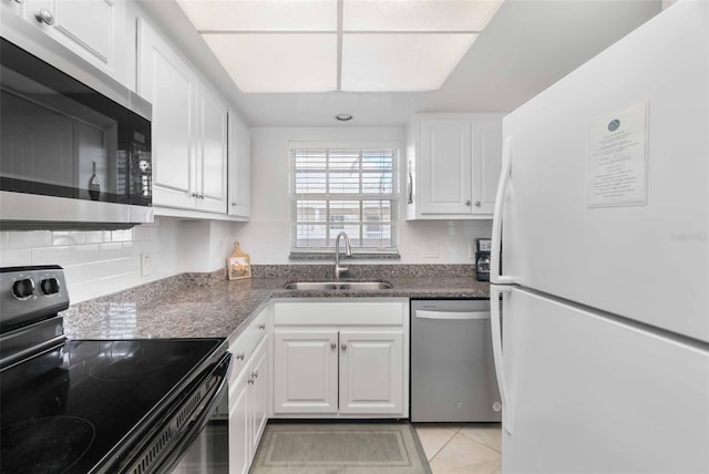 kitchen featuring decorative backsplash, sink, white cabinets, and appliances with stainless steel finishes