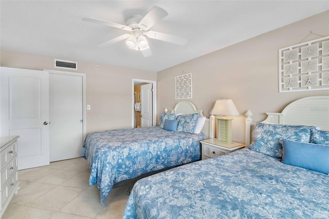 tiled bedroom featuring ceiling fan