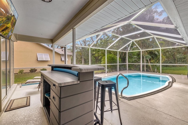 view of swimming pool with a patio and glass enclosure