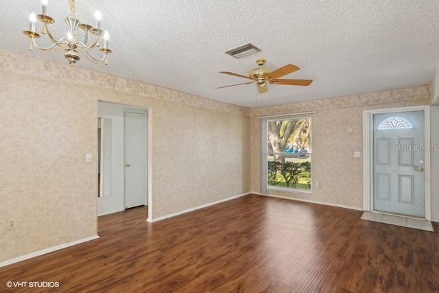 foyer featuring a textured ceiling, ceiling fan with notable chandelier, and dark wood-type flooring