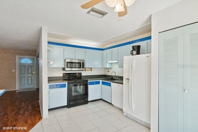 kitchen with ceiling fan, sink, a textured ceiling, white appliances, and light tile patterned flooring