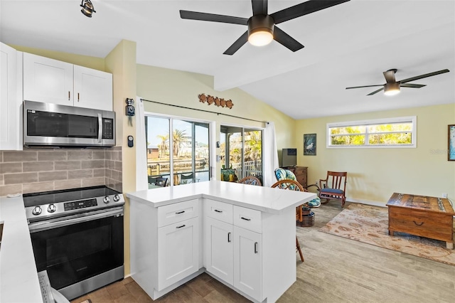 kitchen with stainless steel appliances, white cabinetry, and plenty of natural light