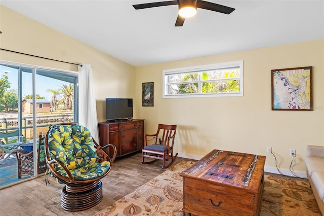 living room with light wood-type flooring, ceiling fan, and lofted ceiling