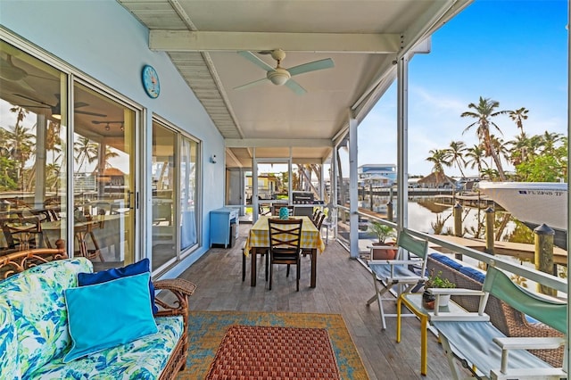 exterior space featuring lofted ceiling with beams, ceiling fan, and a water view