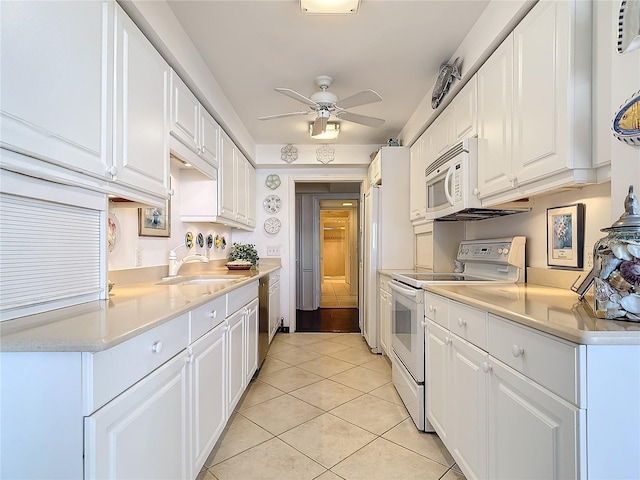 kitchen featuring sink, white cabinets, white appliances, and light tile patterned floors