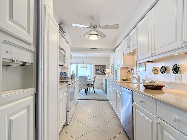 kitchen with white cabinetry, sink, pendant lighting, and appliances with stainless steel finishes