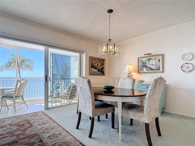 dining space with carpet, a textured ceiling, a water view, and crown molding