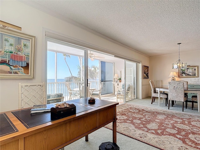 carpeted home office featuring ceiling fan with notable chandelier, crown molding, and a textured ceiling