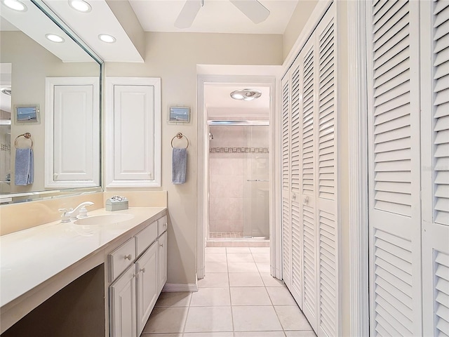 bathroom with tile patterned floors, vanity, and walk in shower