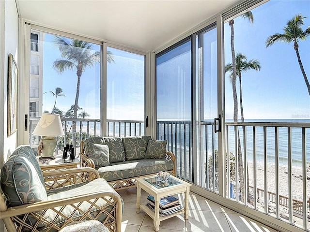 sunroom / solarium with a water view and a view of the beach