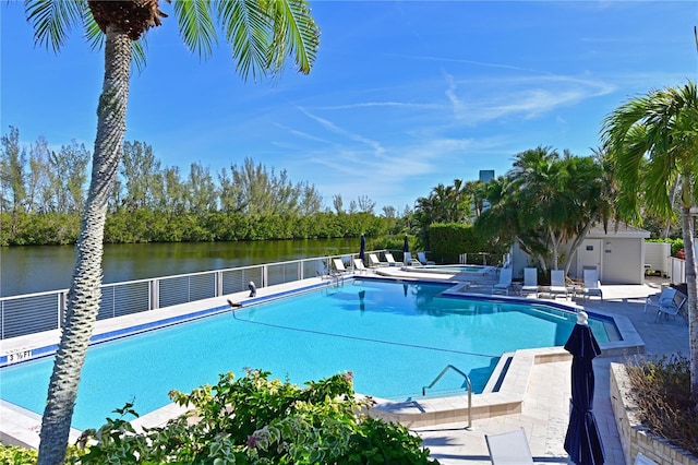 view of swimming pool featuring a water view and a patio area