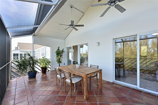 sunroom / solarium with lofted ceiling, ceiling fan, and a healthy amount of sunlight