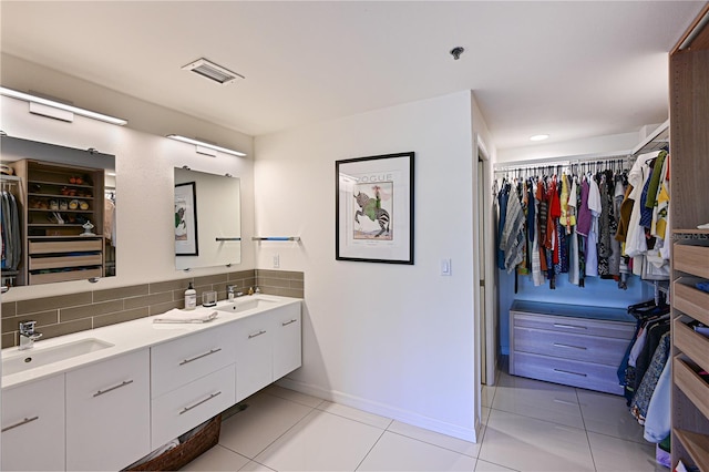 bathroom with tile patterned flooring, vanity, and backsplash