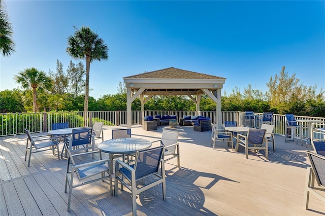 wooden deck with a gazebo and an outdoor living space