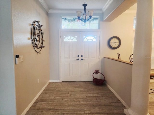 foyer featuring hardwood / wood-style floors, a chandelier, and crown molding