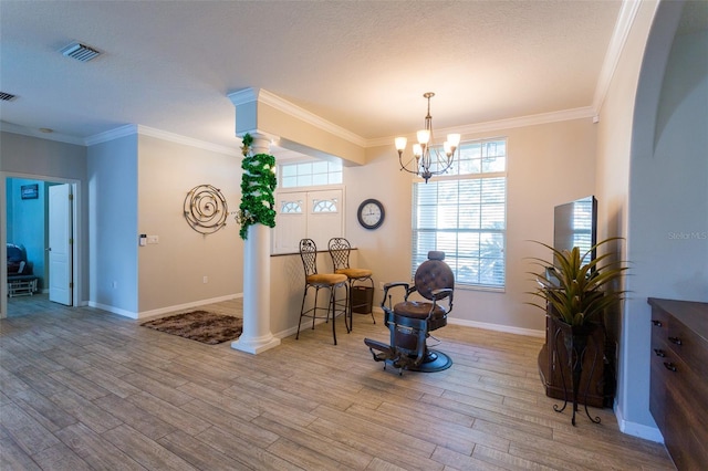 sitting room featuring a notable chandelier, light hardwood / wood-style floors, and crown molding