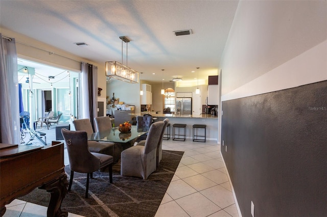 dining space featuring light tile patterned floors