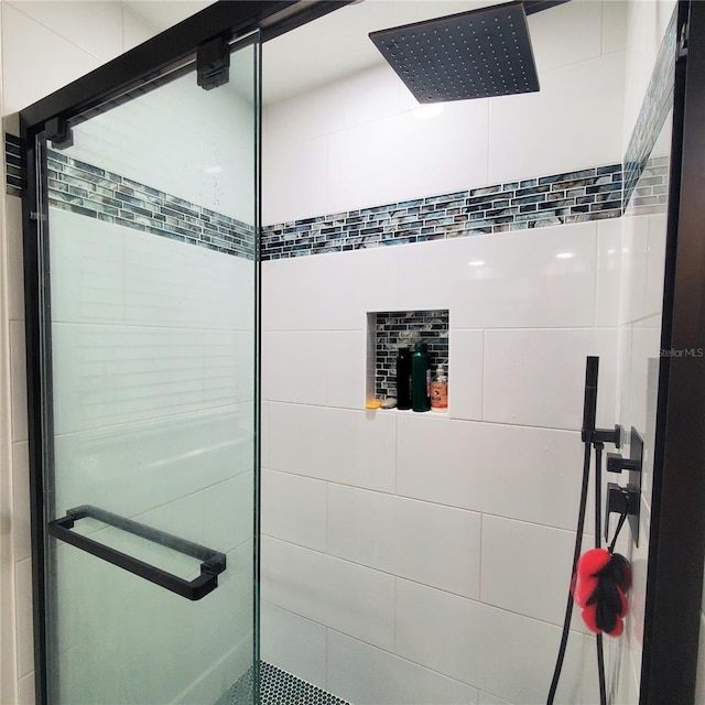 bathroom featuring a shower with shower door