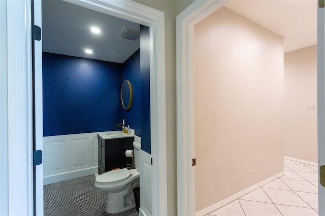 bathroom with tile patterned flooring, vanity, and toilet