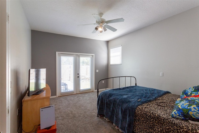 carpeted bedroom featuring french doors, a textured ceiling, access to outside, and ceiling fan