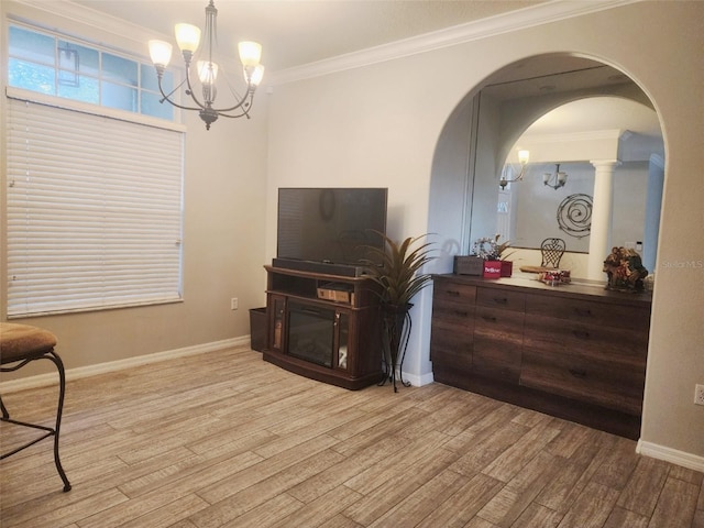 living room featuring ornamental molding, light hardwood / wood-style flooring, and a notable chandelier