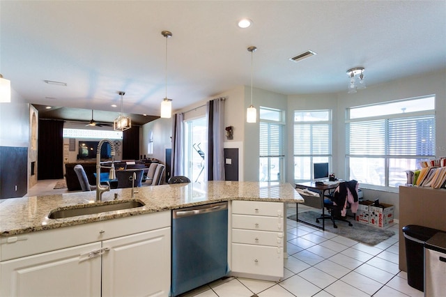 kitchen with white cabinets, hanging light fixtures, sink, and stainless steel dishwasher