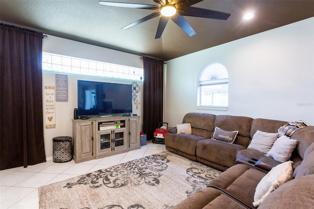 tiled living room featuring a textured ceiling and ceiling fan