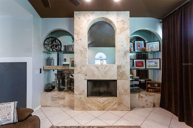 tiled living room featuring a high end fireplace