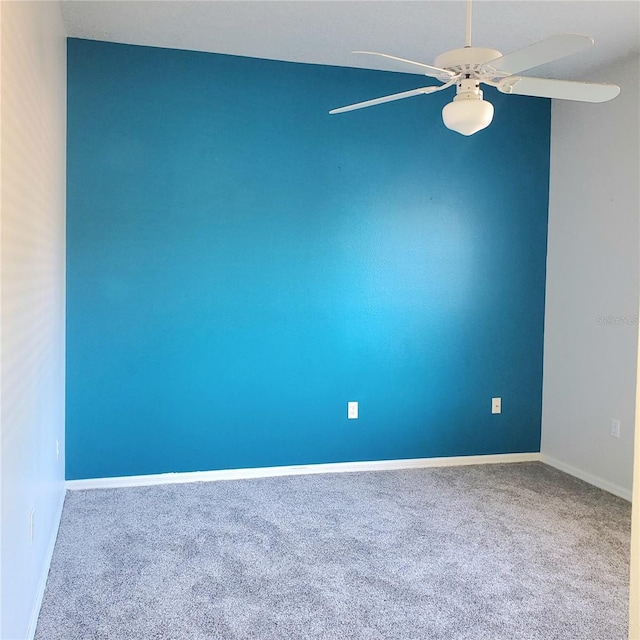 spare room featuring ceiling fan and carpet flooring