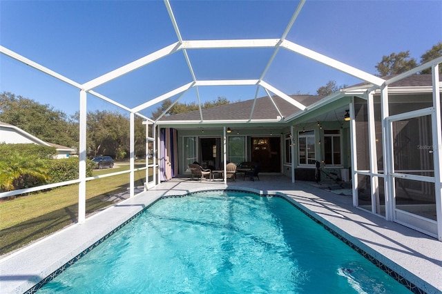 view of swimming pool featuring glass enclosure and a patio