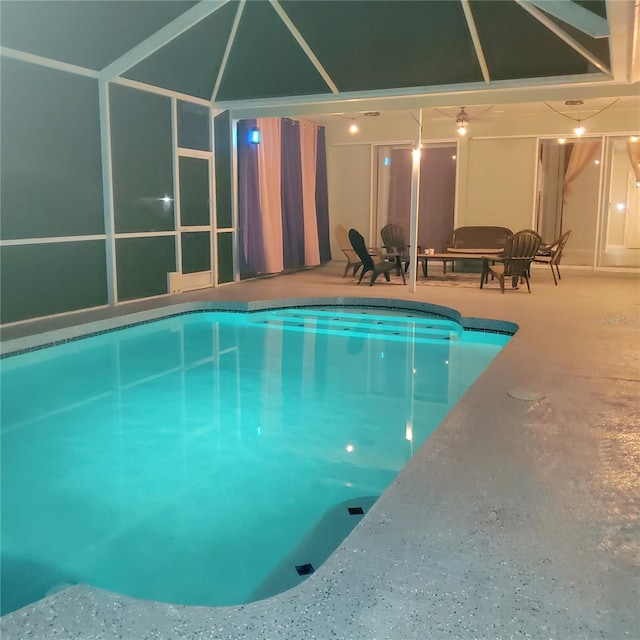 view of swimming pool with a patio and a lanai