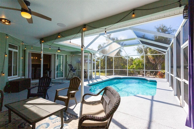 view of swimming pool featuring a patio, ceiling fan, and a lanai