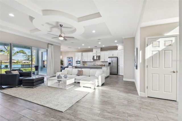 living room with ceiling fan and coffered ceiling