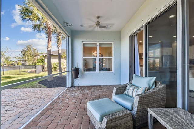 sunroom featuring ceiling fan