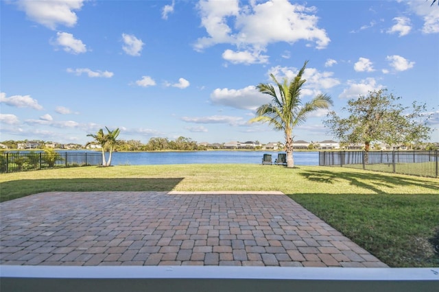 view of yard featuring a water view and a patio