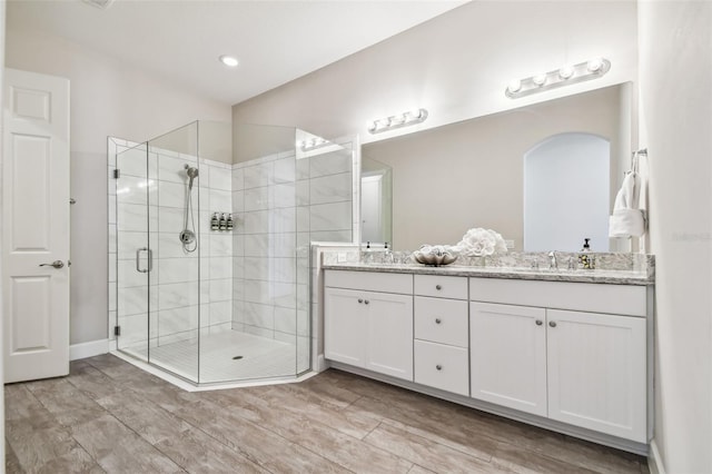 bathroom featuring vanity, hardwood / wood-style flooring, and an enclosed shower