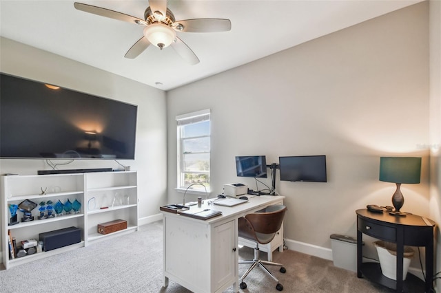 carpeted office featuring ceiling fan