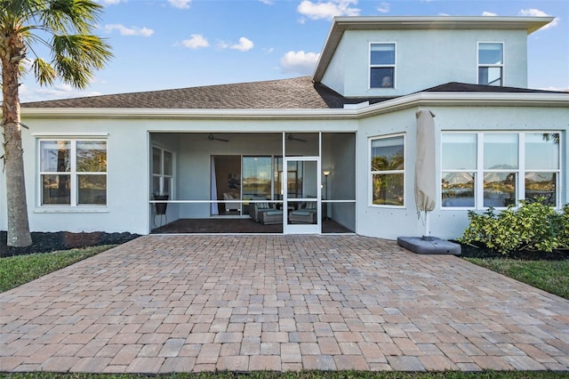 rear view of property with a sunroom and a patio