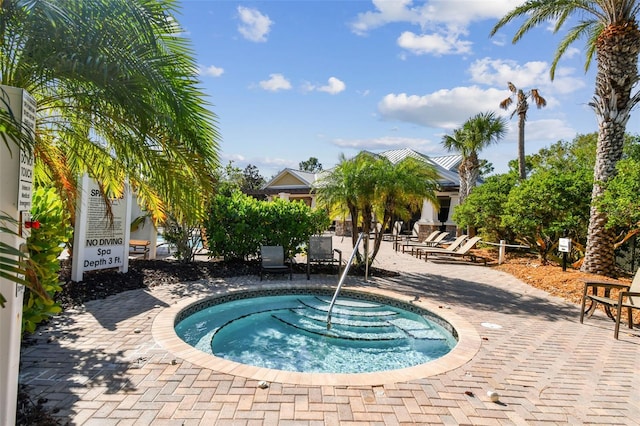 view of swimming pool with a patio area and a community hot tub